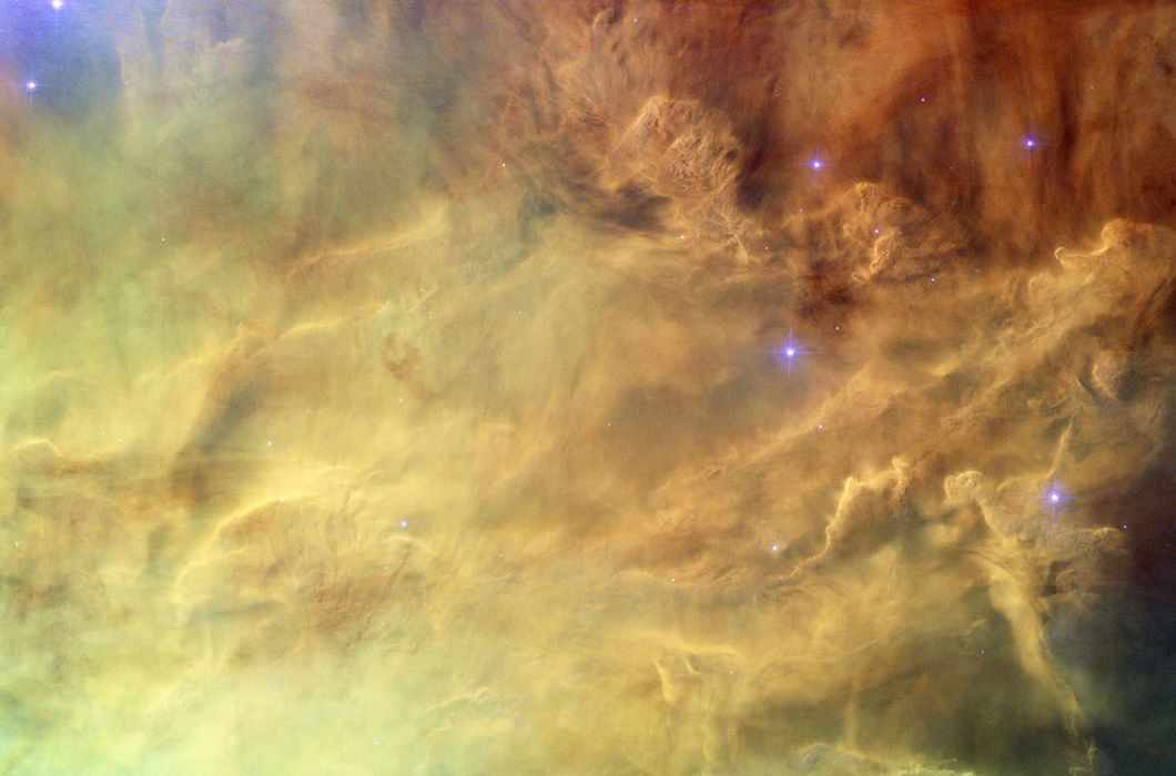 Волны в туманности Лагуны. Снимок центра туманности крупным планом показывает, как излучение молодых звезд взаимодействует с водородным облаком, из которого они образовались. Свет от светящегося водорода окрашен в красный цвет, от ионизированного азота —